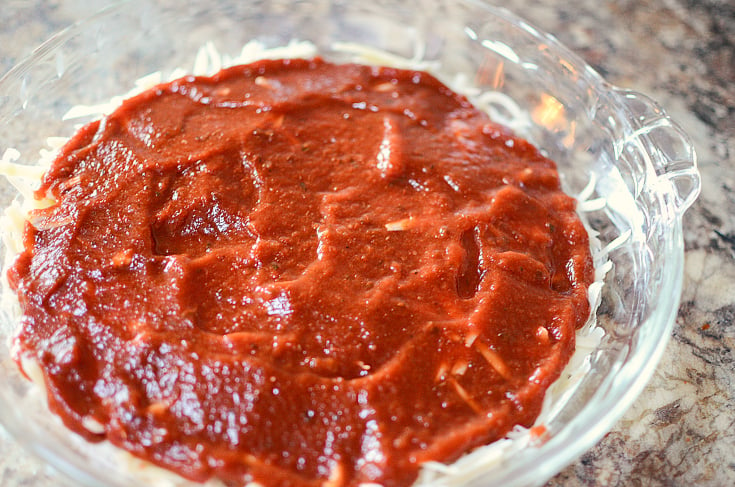 Easy Pizza Dip Recipe - pizza sauce placed on top of shredded cheese