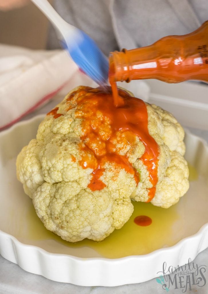 Roasted Buffalo Cauliflower - Brush hot sauce on cauliflower