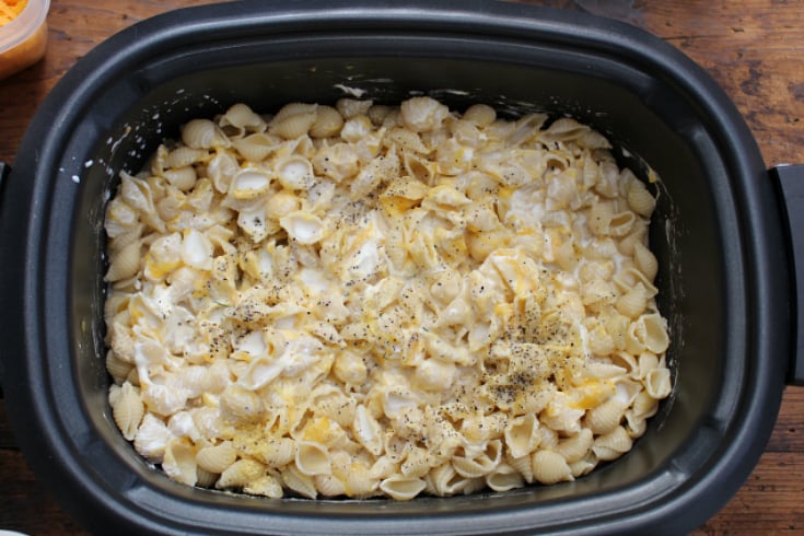 The Best Creamy Crockpot Mac and Cheese - cream soup, milk and seasoning added into slow cooker