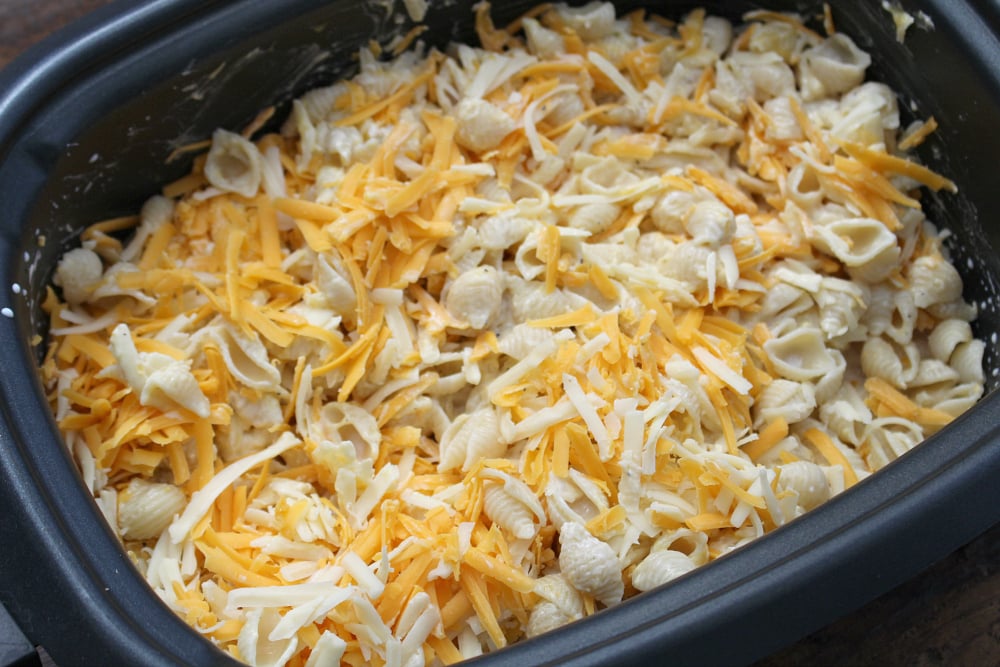 The Best Creamy Crockpot Mac and Cheese - shredded cheeses add to noodle mixture