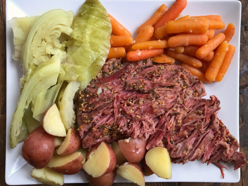 Instant Pot Corned Beef Cabbage served on a white plate