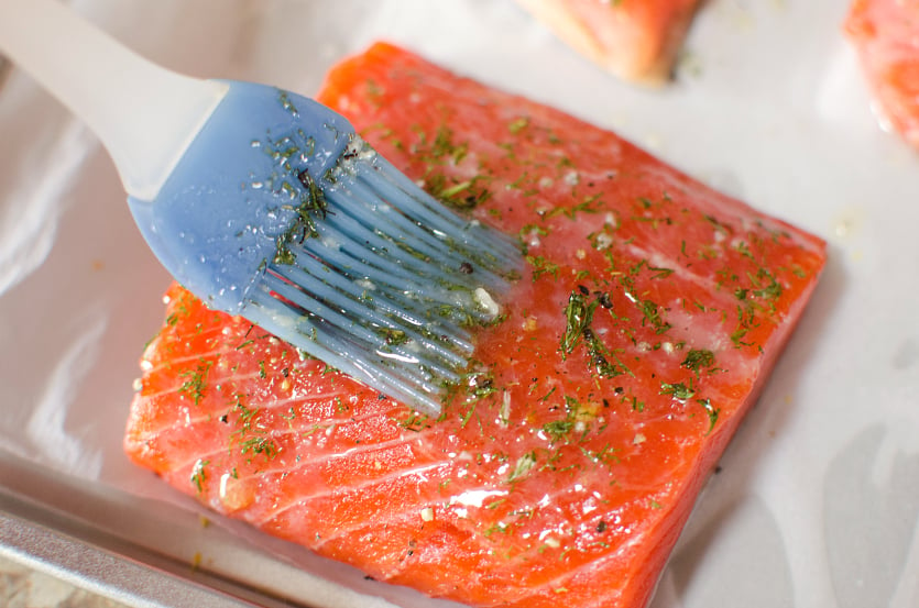 Salmon Sheet Pan Dinner - brush salmon with butter and herbs