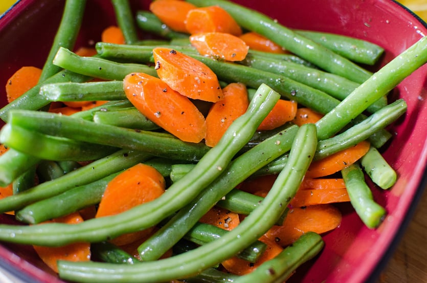 Salmon Sheet Pan Dinner - Season vegetables with oil and seasoning