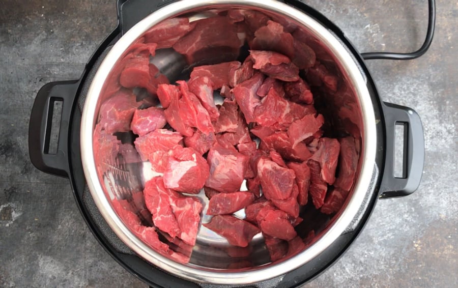 The Best Instant Pot Beef Stew - Raw beef chunks in Instant pot pressure cooker