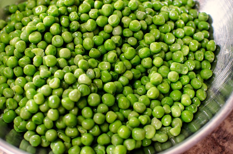 Creamy Bacon Pea Salad - fresh pea in a mixing bowl