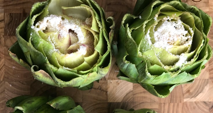 Instant Pot Parmesan Garlic Artichokes - Top artichokes with shredded parmesan cheese