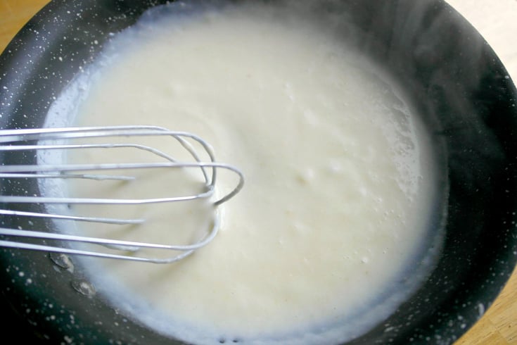 whisking mixture in pan