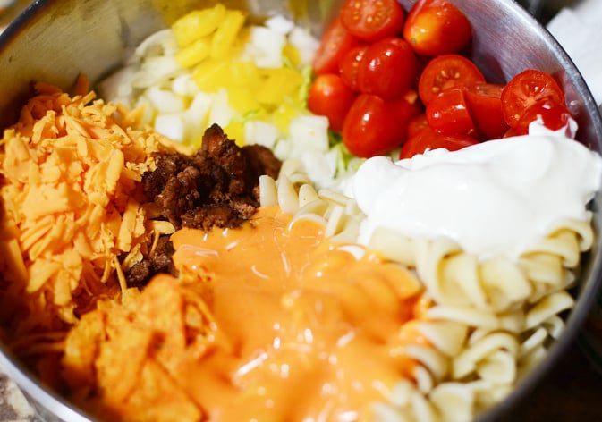 Easy Taco Pasta Salad ingredients in a large mixing bowl