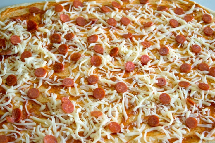 Cheese and mini pepperoni on dough