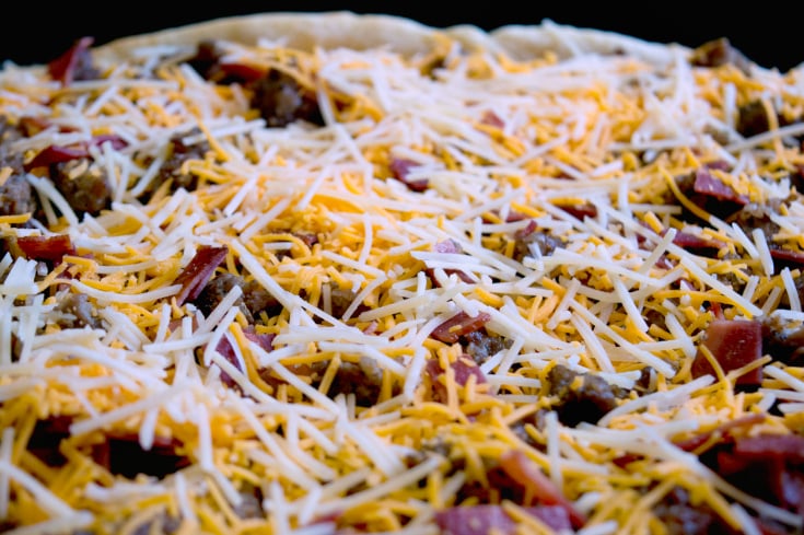 Meat Lovers Breakfast Bake Slab - Shredded cheese and meats placed on top of pie crust