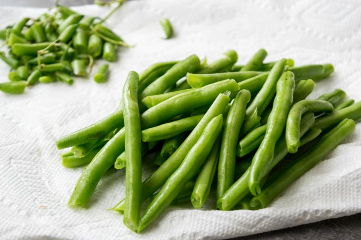 Cheesy Ham Green Bean Casserole - Fresh green beans trimmed and on a paper towl