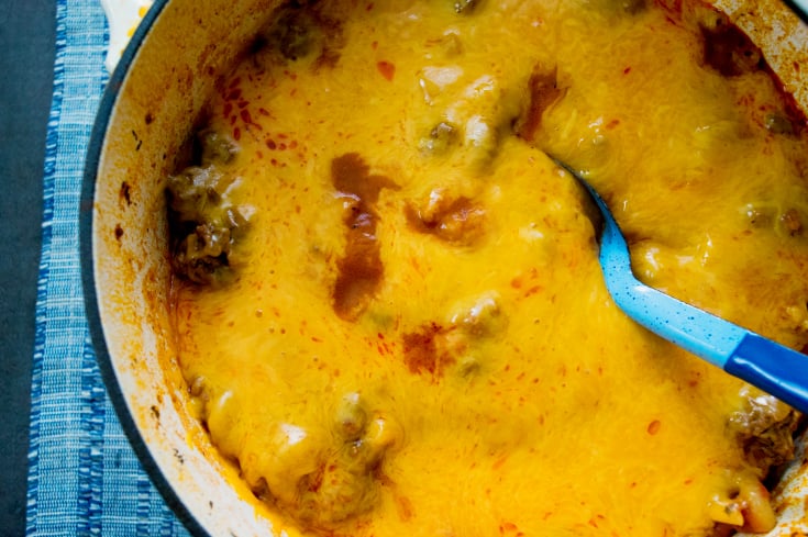 Grandma's Easy Goulash Recipe in a dutch oven topped with melted cheese