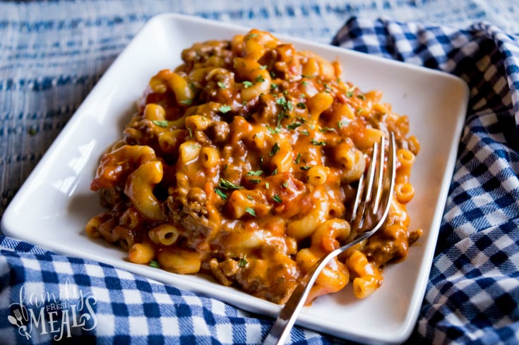 Grandma's Easy Goulash Recipe served on a white plate with a fork. Family Fresh Meals