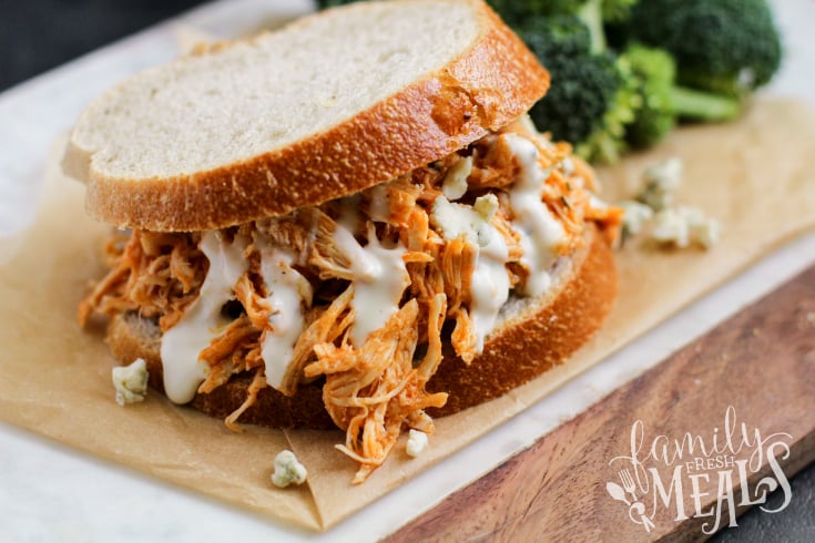 Crockpot Buffalo Chicken Sandwiches --- A family favorite sandwich topped with dressing and cheese - Family Fresh Meals