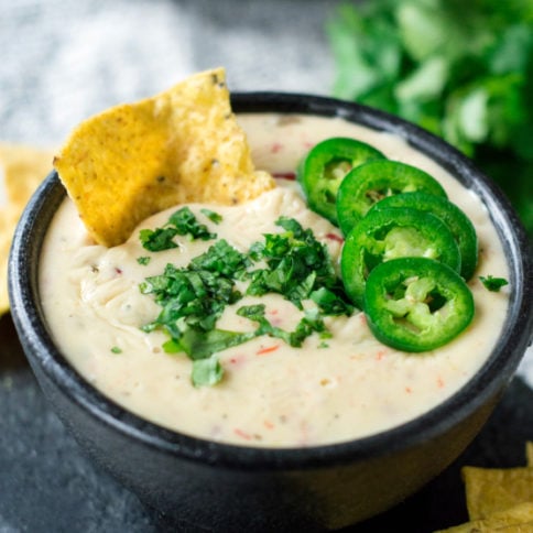 Crockpot White Queso Dip - Dip served in a bowl with chips - Family Fresh Meals