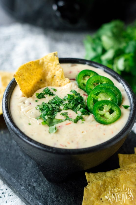 Crockpot White Queso Dip - Dip served in a bowl with chips - Family Fresh Meals