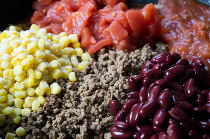 Chili Stuffed Cornbread Casserole - Ground beef, corn, tomatos, beans and salsa in a skillet