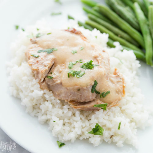 Pork Chops served over rice with a side of green beans