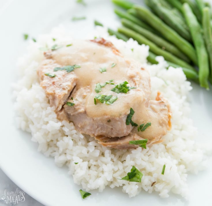 Pork Chops served over rice with a side of green beans