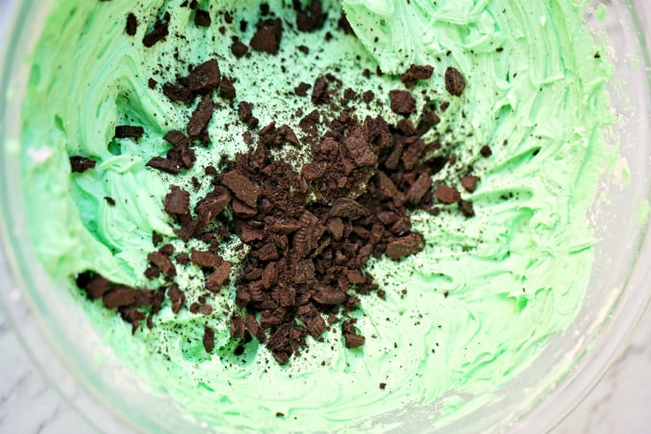 Mint Chocolate Brownies - Mint frosting and crush Oreos in a bowl
