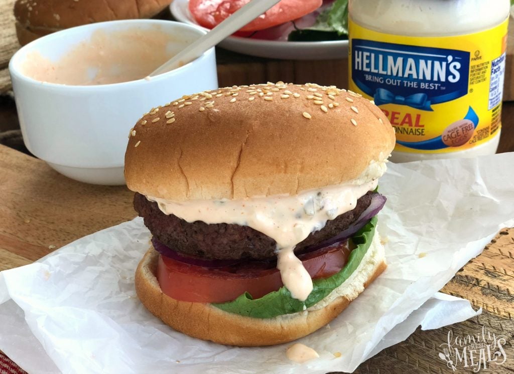 Come Back Burger Sauce Recipe - Hamburger on parchment paper with sauce dripping down the side.