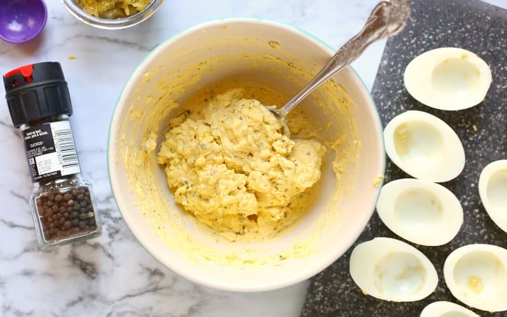 Blue Ribbon Deviled Eggs - Egg yolks mixed in a white bowl