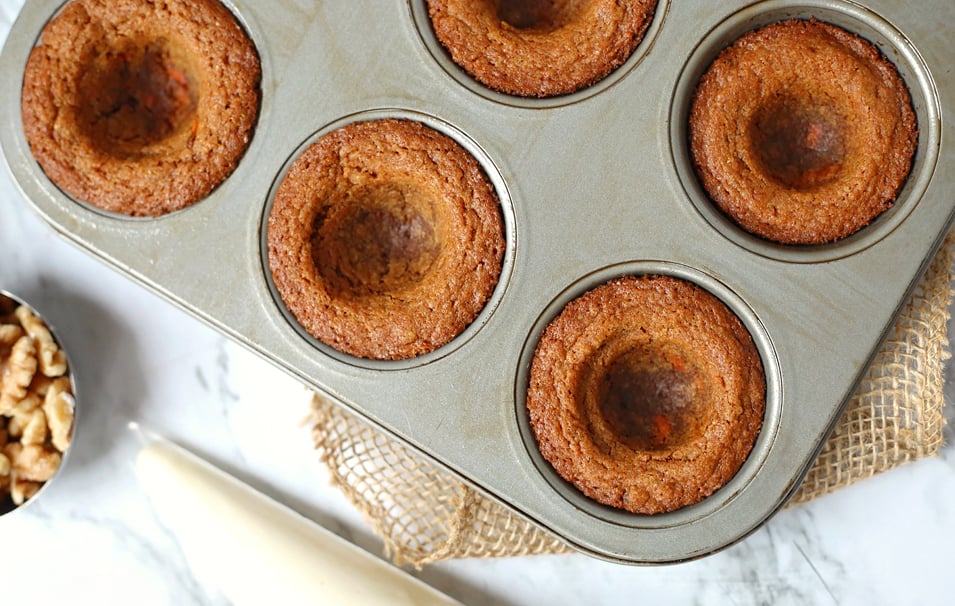 Carrot Cake Cookie Cups - carrot cake cups in muffin tin, with centers pushed in