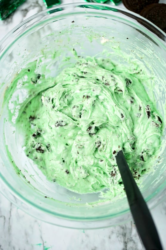 Mint Chocolate Chip Dip - green dip mixed with a spatula