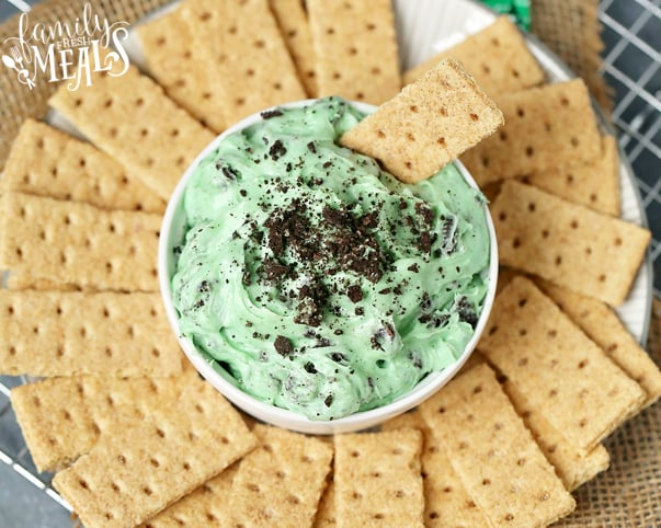 Mint Chocolate Chip Dip - green dip served in a white bowl with graham crackers