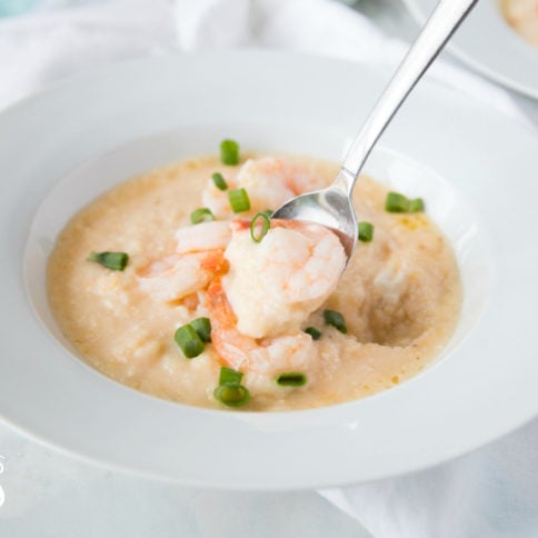 Crockpot Cheesy Grits and Shrimp served in a white bowl