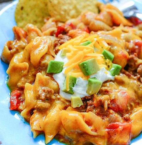 Instant Pot Taco Pasta - Taco past served on a blue plate. Family Fresh Meals
