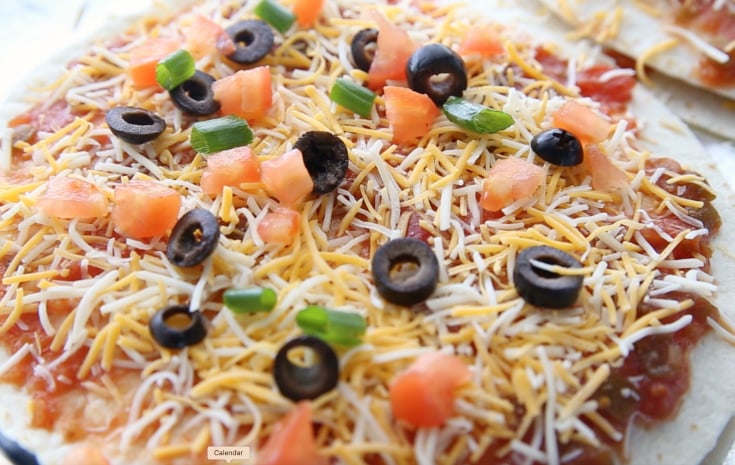 Copycat Taco Bell Mexican Pizza Stacks - Tortillas cheese, black olives and tomatoes