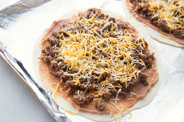 Copycat Taco Bell Mexican Pizza Stacks - Tortillas topped with refried beans, beef and cheese
