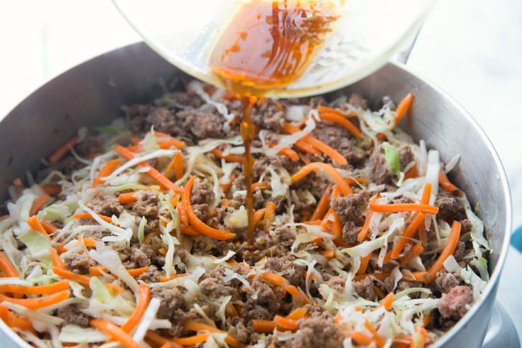 Healthy Egg Roll Stir Fry - sauce pouring into pan