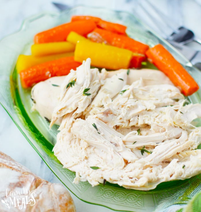 How to Make an Instant Pot Whole Chicken - Chicken served on a green plate with carrots