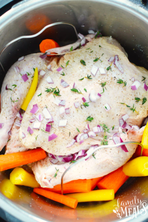 How to Make an Instant Pot Whole Chicken - Whole chicken, carrots and seasoning in the Instant Pot - Family Fresh Meals