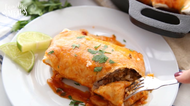 One Pan Smothered Beef Burrito Skillet - Cutting a bite into the burrito with a fork