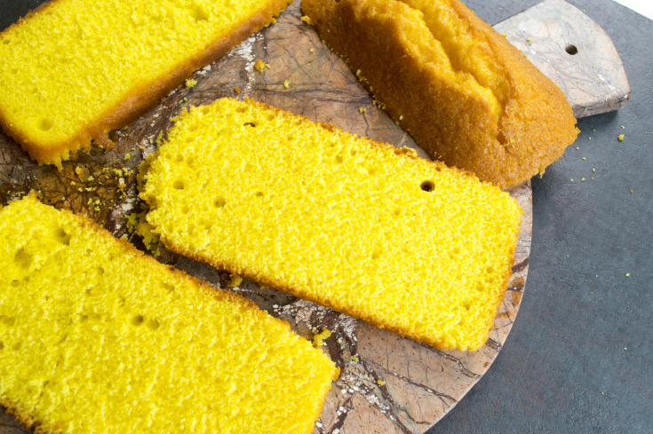 Easy Lemon Ice Cream Cake - Sliced pound cake on a cutting board