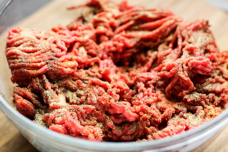 Fully Loaded Burger Bowls - raw ground beef in a glass bowl with seasoning