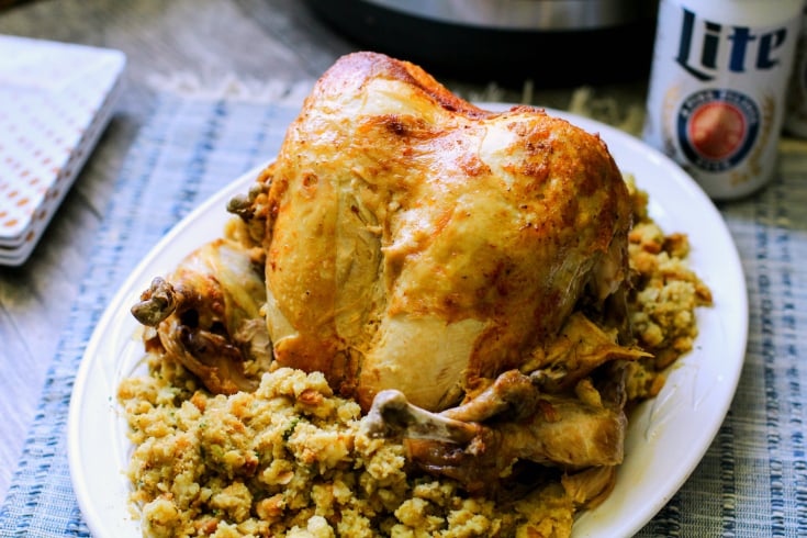 Instant Pot Beer Can Chicken - Beer Can Chicken served on a white plate with stuffing