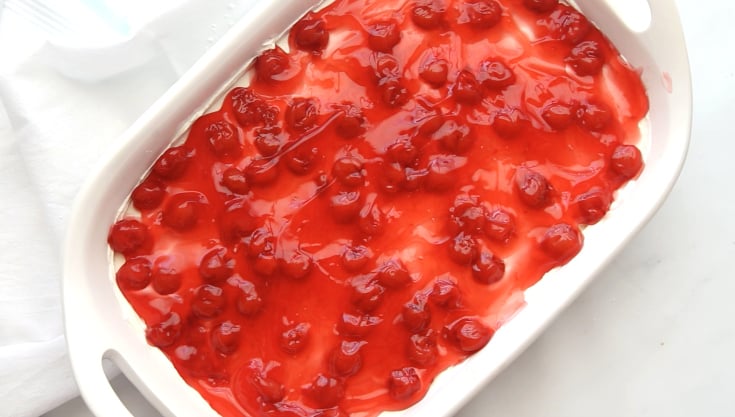 No Bake Cherry Cheesecake Dessert - Cherry filling spread on top of dessert