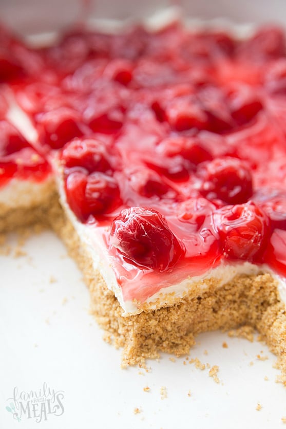 No Bake Cherry Cheesecake Dessert  in baking pan with slices removed