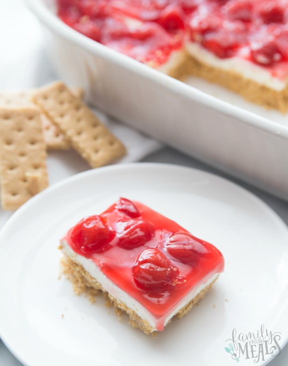 No Bake Cherry Cheesecake Dessert Recipe - Family Fresh Meals Slice of dessert on a white plate