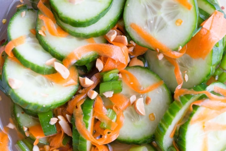 Thai Cucumber Salad - cucumber slices, carrot shreds, in a glass bowl with sauce