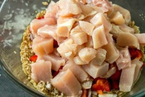 Aloha Pineapple Chicken Rice Casserole - diced chicken, rice, soy sauce, peppers, onion, sugar and chicken broth in a large glass bowl