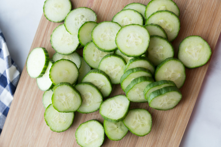 Easy Refrigerator Pickles - sliced cucumbers on a cutting board