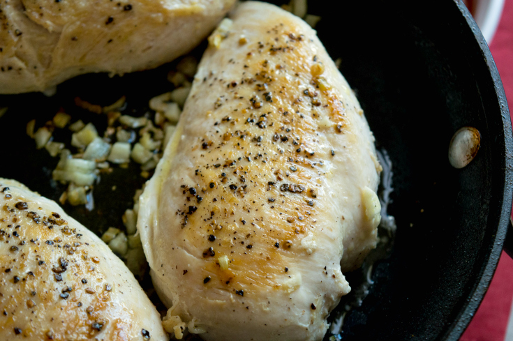 Pizza Chicken Bake - Chicken breast cooking in a pan