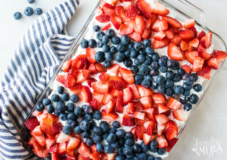 Red White and Blue Poke Cake - White cake with holes poked in it and topped with fresh berries.