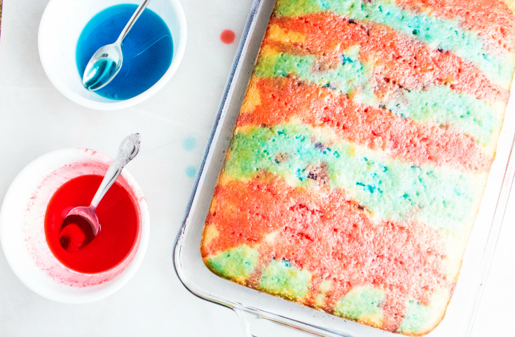 Red White and Blue Poke Cake - White cake with holes poked in it and topped with red and blue liquid