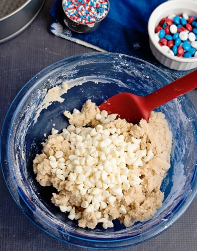 Sugar Cookie Cake - Mixing white chocolate chips into dough mix